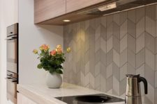22 the interest is added with chevron tiles of various shades of grey