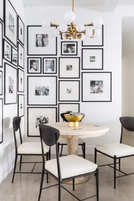 a breakfast nook made more special with a corner gallery wall with black frames and family pics