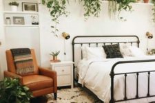 23 a ledge over the bed with lots of planters and pots with cascading greenery