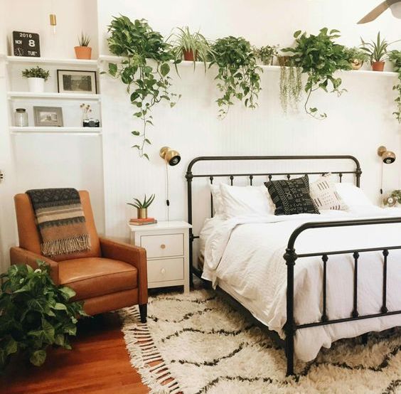 a ledge over the bed with lots of planters and pots with cascading greenery