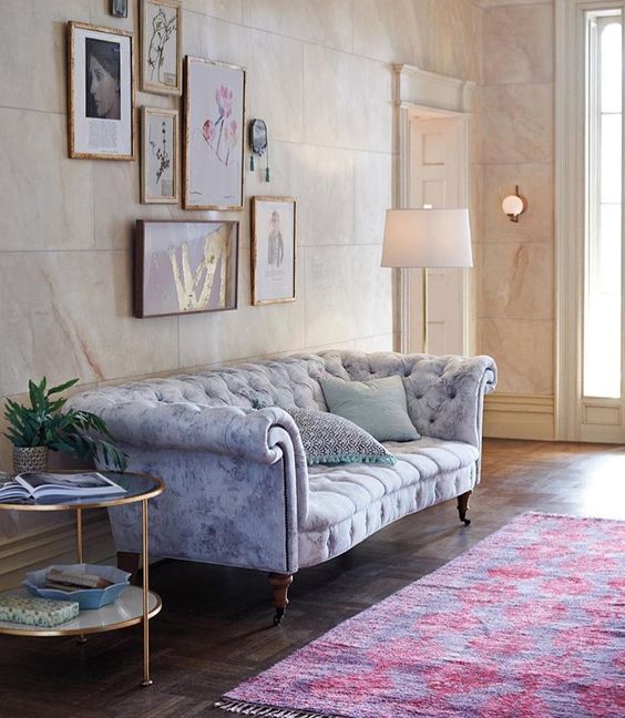 a watercolor grey and blue Chesterfield with exquisite legs and armrests
