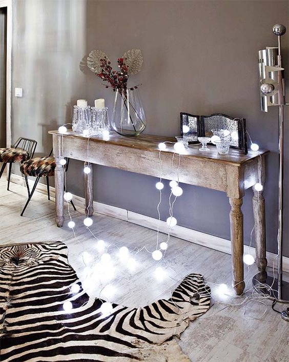 ball-shaped string lights on a vintage wooden console table for a more modern feel