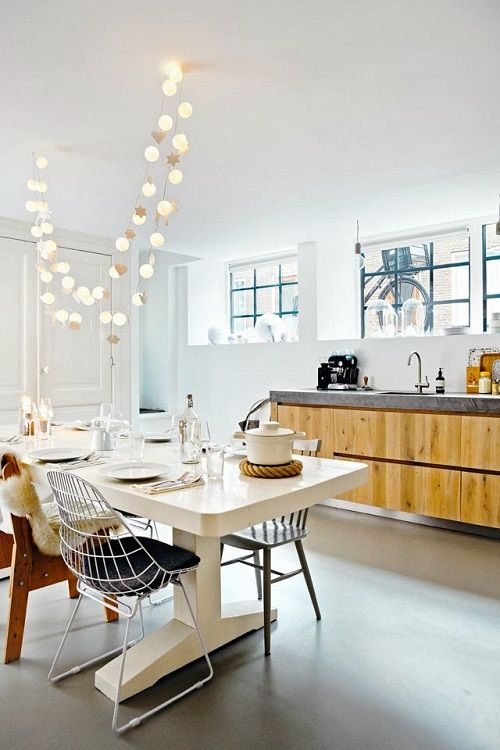 fun string lights hanging over the dining space in the kitchen to accent it