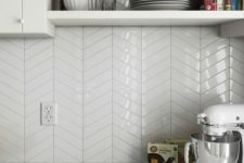 23 glossy white chevron tiles add an edgy geo touch to the neutral space