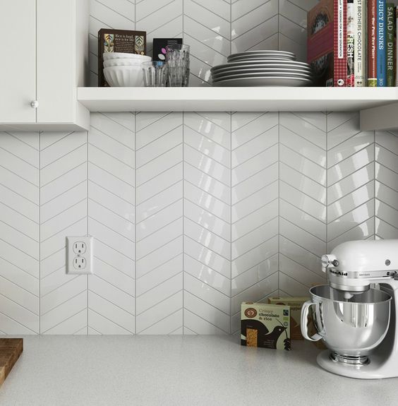 glossy white chevron tiles add an edgy geo touch to the neutral space