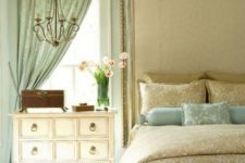 23 the neutral bedroom is spruced up with a mint-colored curtain and matching pillows