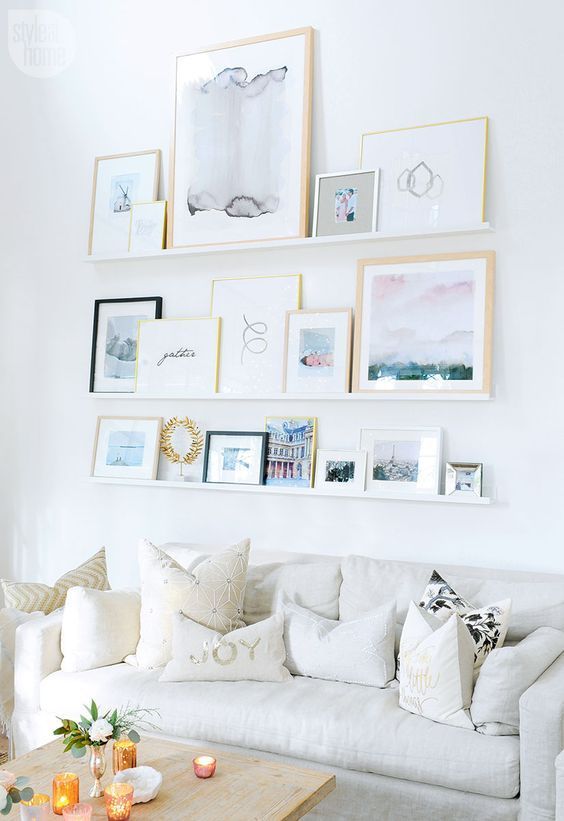 a seaside-inspired gallery wall placed on ledges to change the place and artworks easily