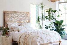 24 potted plants and greenery in the corner becomes a natural part of this boho space