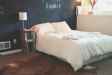 24 string lights over the bed cheer up the chalkboard wall and make the space cooler