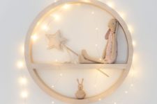 25 a circle toy shelf with string lights covering it for a highlight
