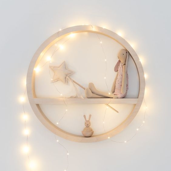 a circle toy shelf with string lights covering it for a highlight