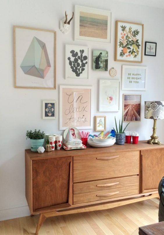 A gallery wall with mid century modern and boho chic wall art pieces