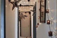 25 lots of string lights hanging from the ceiling with pinecones, garlands and buntings for holiday decor