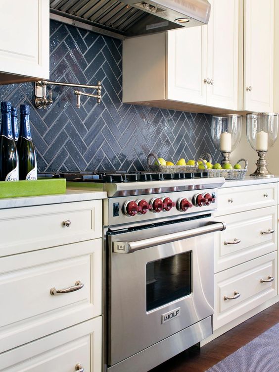 navy chevron tile backsplash stands out in a neutral farmhouse kitchen