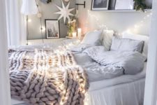 25 string lights over the bed and on the wall to make your sleeping space cozier