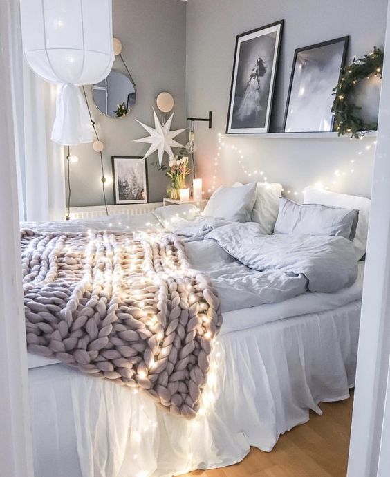 string lights over the bed and on the wall to make your sleeping space cozier