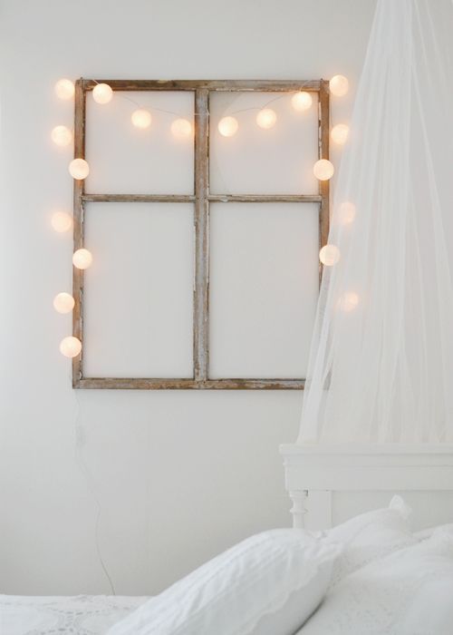 a faux window with string lights adds to the ambience and makes the space comfier