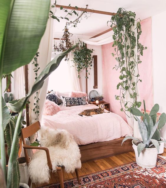 potted plants and cascading greenery hanging on the bed frame to feel outside