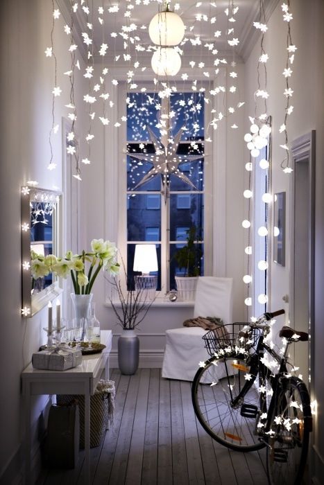 Star shaped string lights hanging from the ceiling and covering the bike for a dream ambience