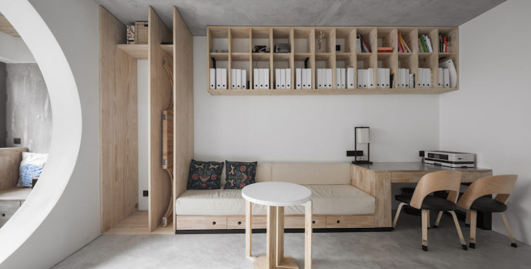 The living room features a unit that combines a sofa, desk and a storage cabinet