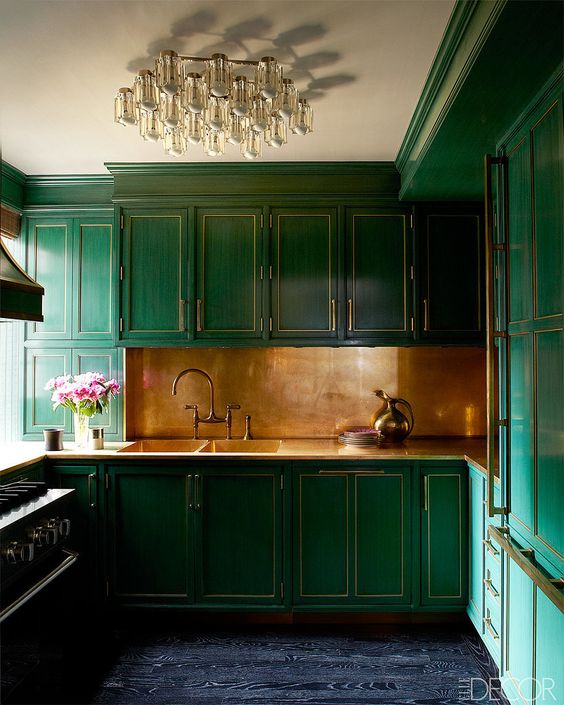 a brushed brass backsplash with art deco emerald cabinets look fantastic and very bold