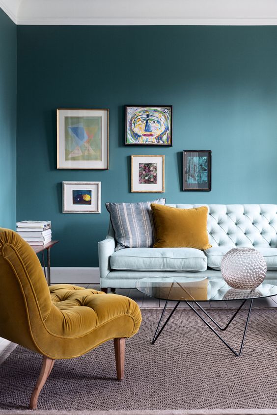 an asymmetrical colorful gallery wall makes a trendy statement in the living room