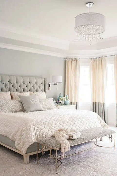 color block blush and grey curtains add a tender feel to the room and highlight its glam style