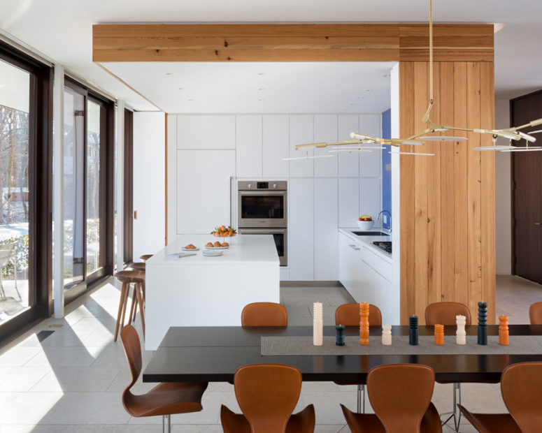 The kitchen block features its own ceiling with built-in lights and wood cladding the side and ceiling