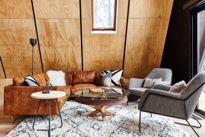 The spaces inside are covered with honey-toned plywood, which makes them cozier and warmer