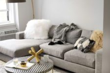 03 a comfy grey, creamy and gold living room with a large grey sectional sofa that takes half a space