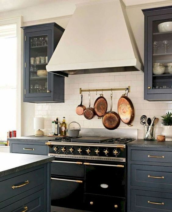 Make a neutral backsplash more eye catchy with a rail and vintage pots and frying pans