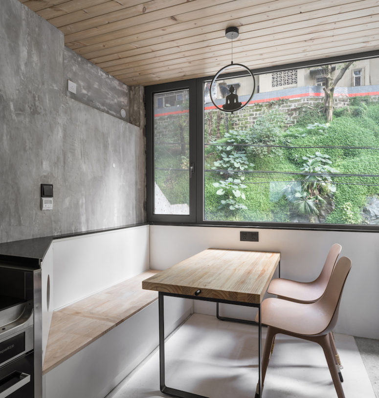 The dining space features a storage bench and cool views