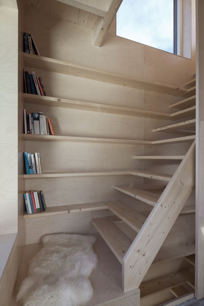 The stairs are prolonged with bookshelves, so every inch of space is used at its best, there's no unnecessary item