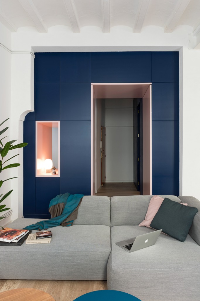 The storage is hidden behind these navy panels, it's sleek and very practical