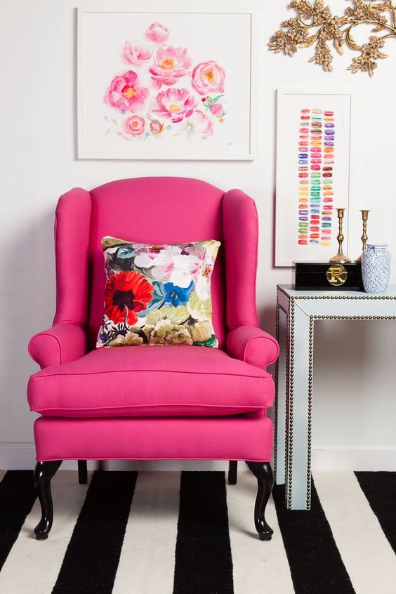 a boring classic wingback is given a fresh look with hot pink upholstery to match a girlish space