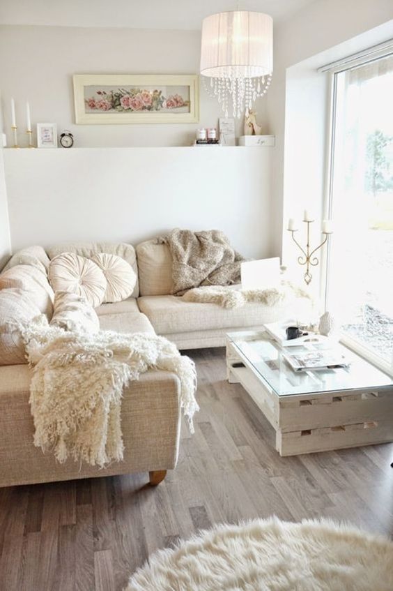 A cozy rustic space with a glam feel and a large sectional creamy sofa that defines the space