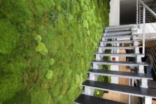04 a fresh moss wall next to the staircase creates a feel of an indoor garden