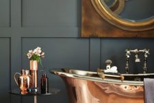 05 a brass free-standing bathtub, a matching table and vases for a refined and catchy look