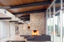 05 a modern rich-colored wooden ceiling with black metal ceiling beams for a minimalist look