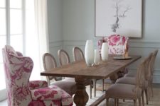 05 a vintage rustic dining room is spruced up with pink floral upholstery wingback chairs