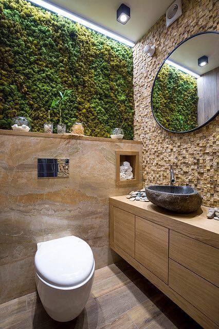 An eco friendly bathroom with a moss wall and some wood and stone in decor