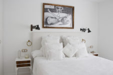 06 The master bedroom is spruced up with a cool artwork, vintage nightstands and a inviting bed with lots of pillows
