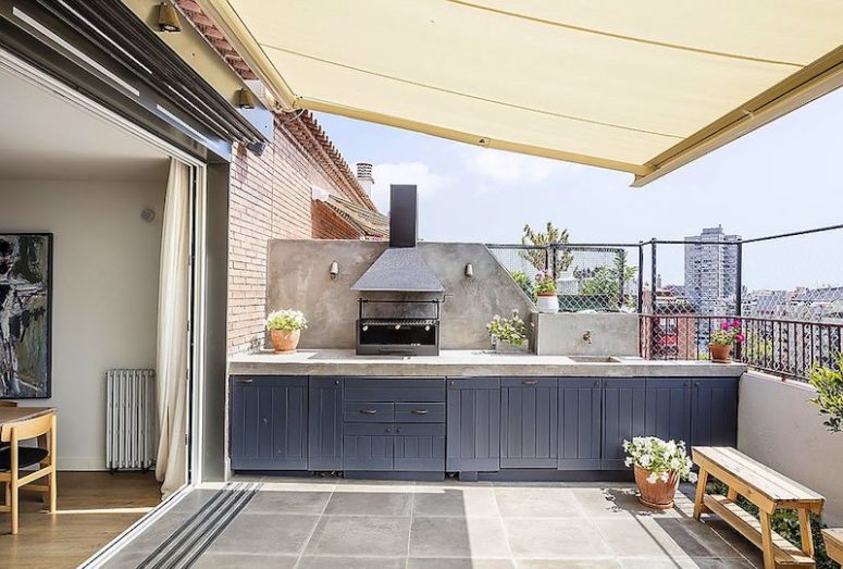 The terrace features a kitchen with a grill and much storage in the cabinets