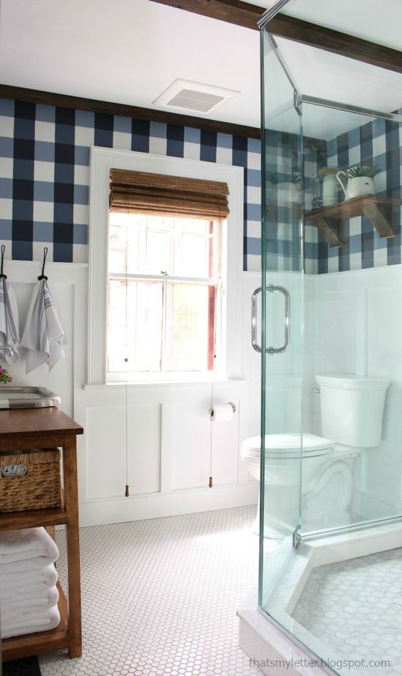a rustic space with navy, blue and white wallpaper and wooden touches for a cozy and welcoming feel
