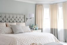 06 a serene bedroom in blush and grey, with a glam chandelier and a refined bench at the foot