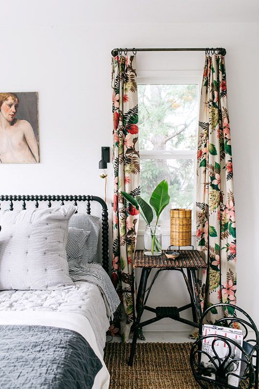 vibrant floral curtains add a vivacious touch to the bedroom and make it more eye-catchy