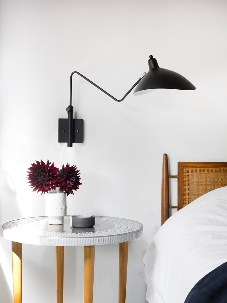 Sconces, nightstands and all the accessories are perfectly styled to fit the room