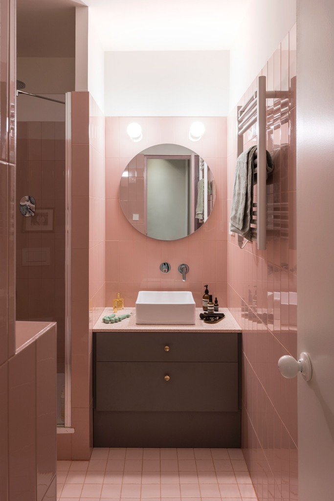 The bathroom is also done in pink, with pink tiles and with some neutral and grey touches for a contrast
