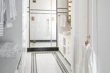 07 The master bathroom is done with black and white tiles and some brass touches for an elegant vintage feel