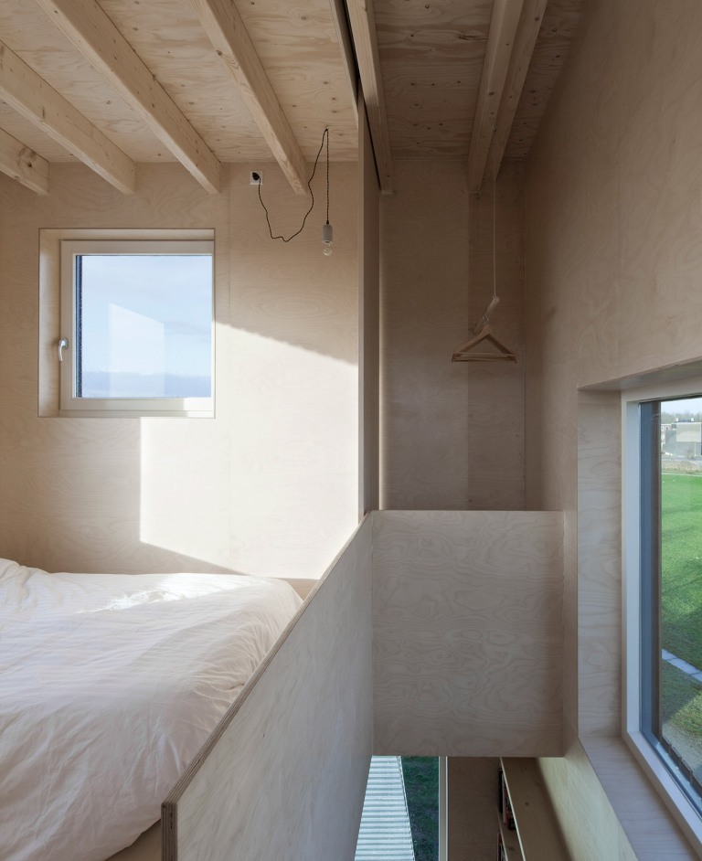 The top floor shows off a bed and an open wardrobe, and there's much natural light too